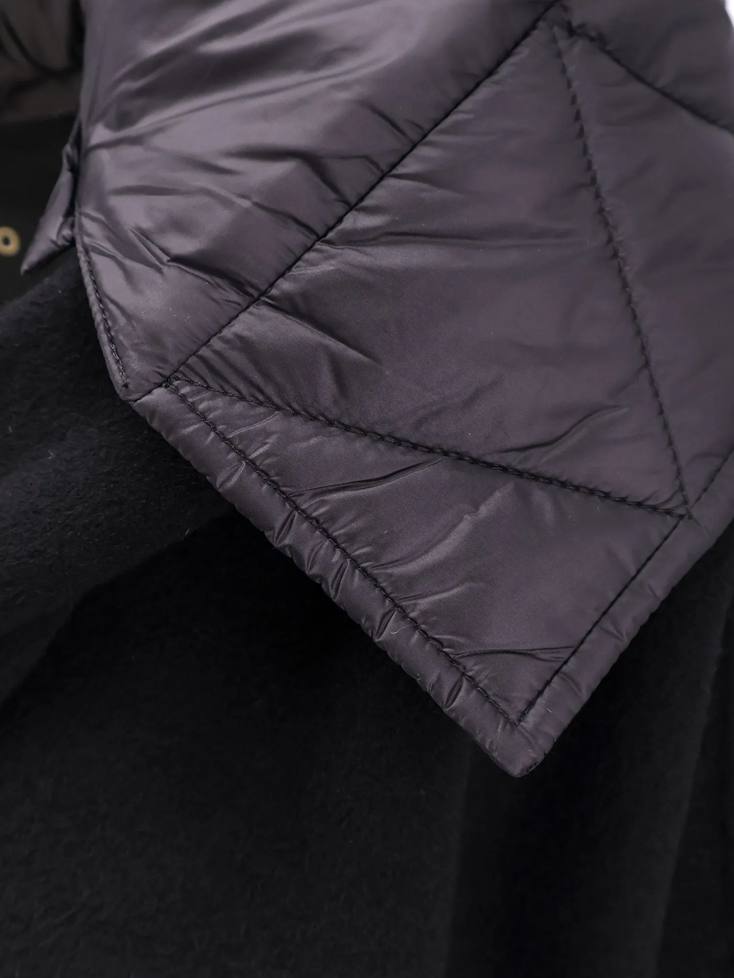 Wool coat with quilted nylon inserts